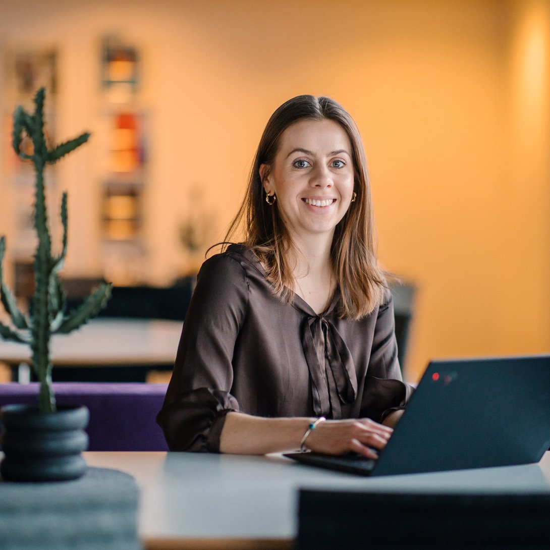 Woman sitting at a table with her laptop