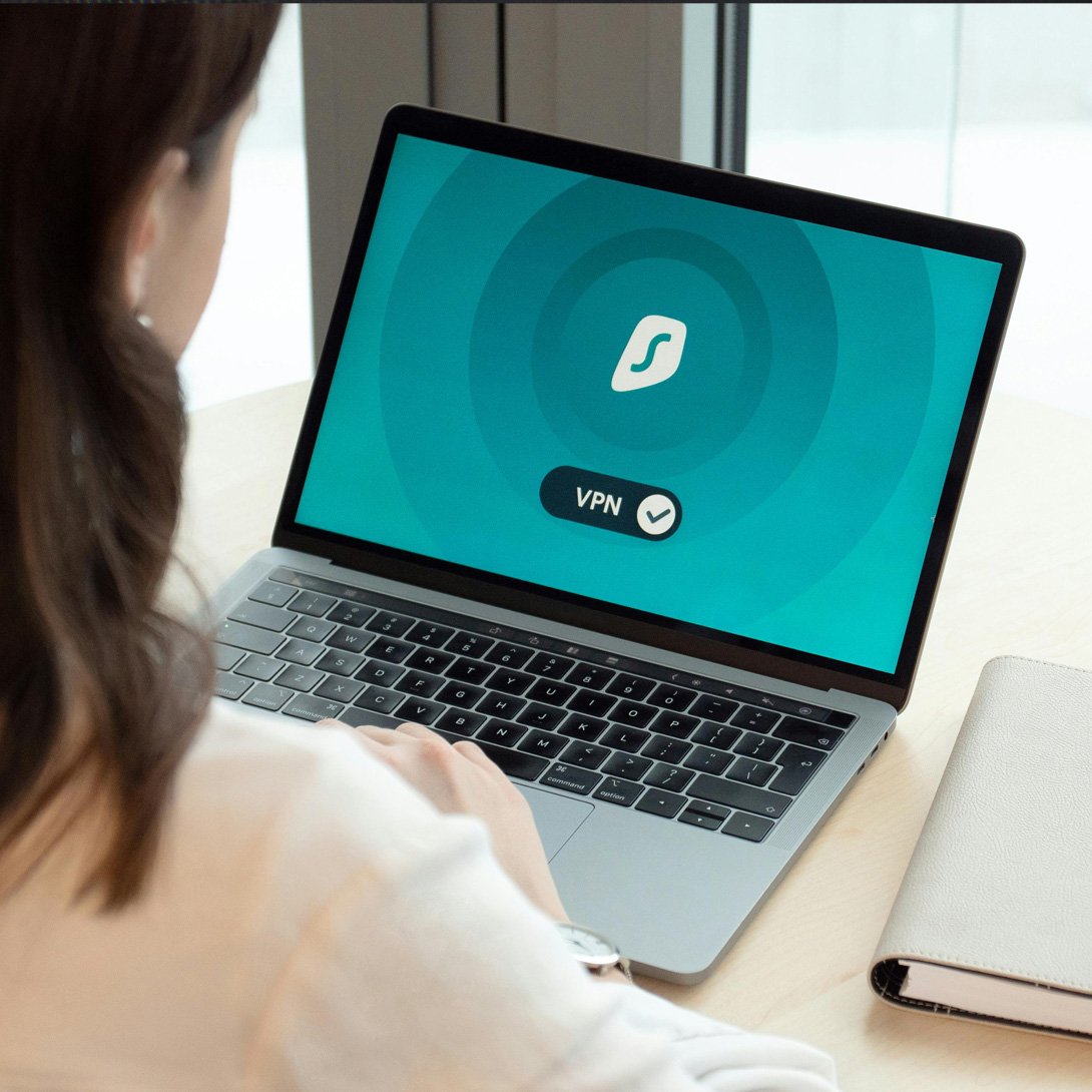 woman sitting at laptop and connecting to vpn 